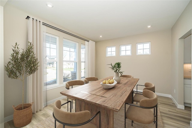 dining space featuring a wealth of natural light and light hardwood / wood-style flooring