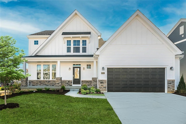 view of front facade with a front lawn, a porch, and a garage