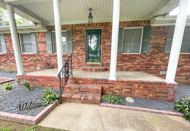 entrance to property featuring covered porch