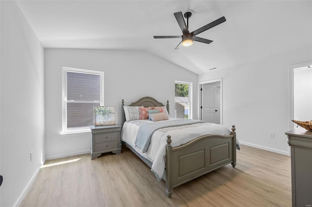 bedroom featuring lofted ceiling, ceiling fan, and light wood-type flooring