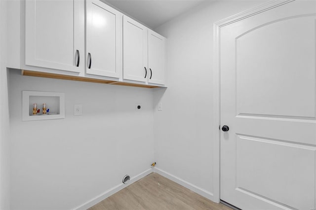 laundry room with gas dryer hookup, cabinets, hookup for a washing machine, electric dryer hookup, and light hardwood / wood-style flooring