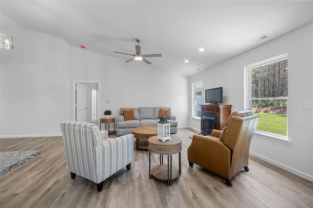 living room with ceiling fan and light hardwood / wood-style flooring