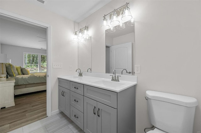 bathroom featuring hardwood / wood-style flooring, vanity, and toilet