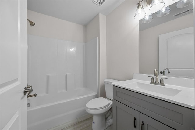 full bathroom featuring vanity, hardwood / wood-style flooring, shower / washtub combination, and toilet