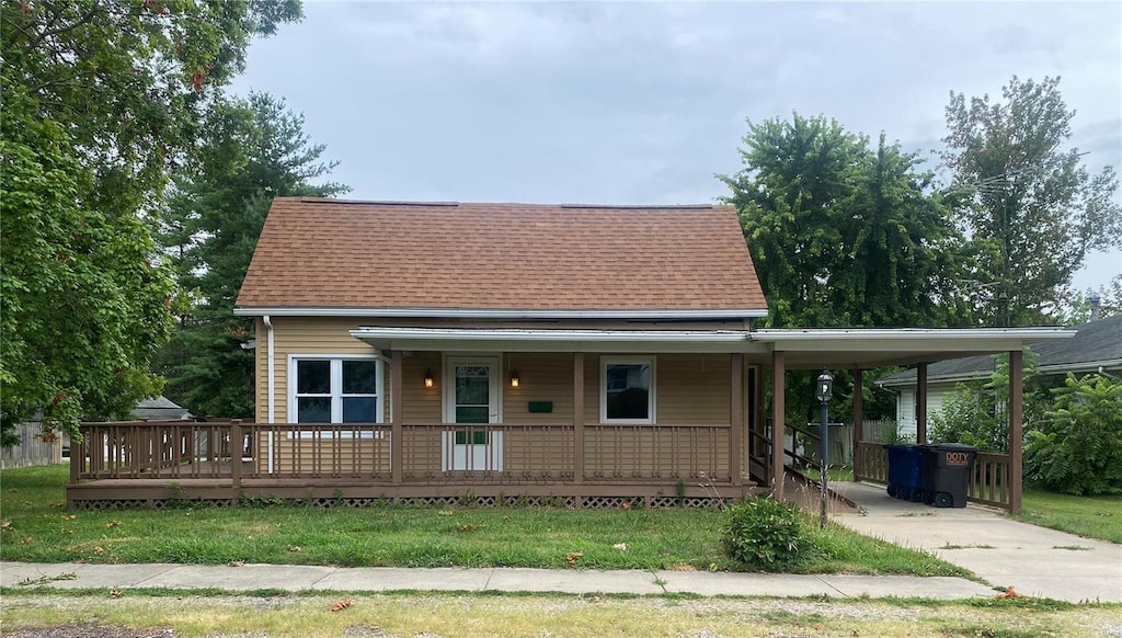 view of front facade with a carport and covered porch