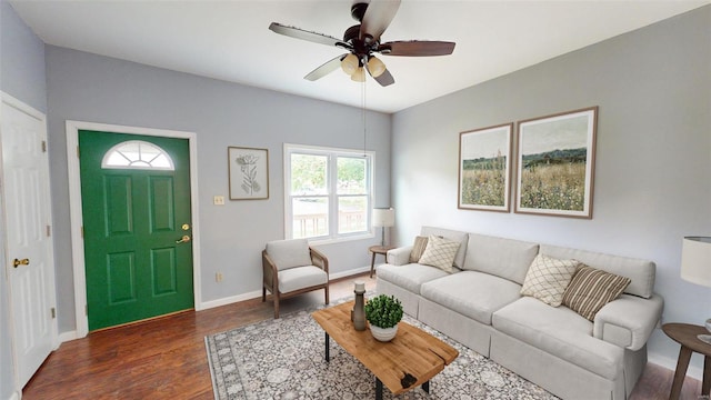 living room featuring ceiling fan and dark hardwood / wood-style floors