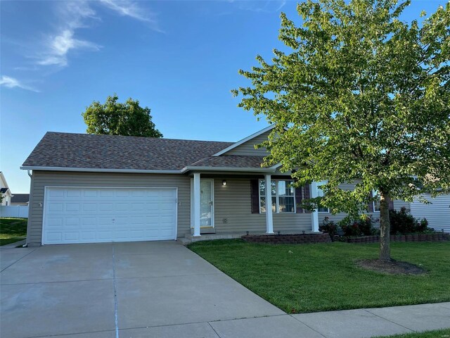 view of front of property with a garage and a front yard