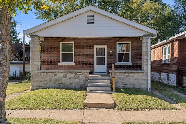 bungalow-style house with a front yard