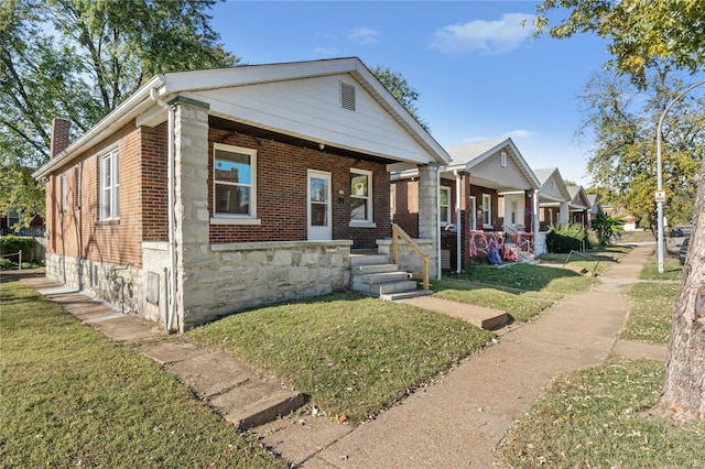 view of front of house with a front yard and covered porch