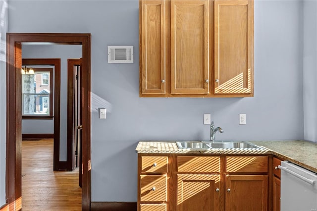 kitchen featuring sink, light hardwood / wood-style floors, and dishwasher