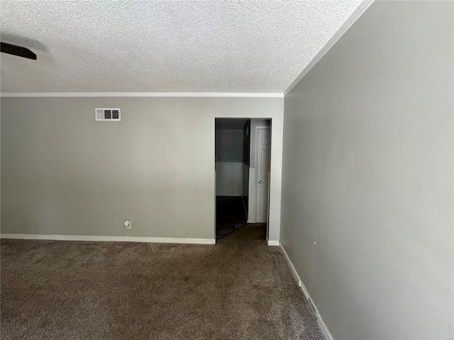 empty room with carpet flooring, crown molding, and a textured ceiling