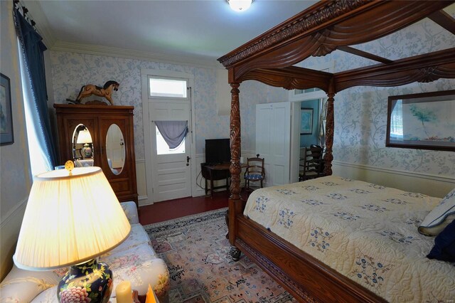 bedroom with crown molding and hardwood / wood-style flooring