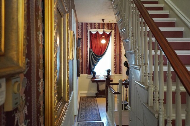 hallway with dark tile patterned floors