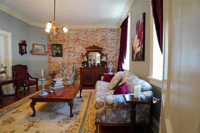 living room with hardwood / wood-style flooring, ornamental molding, and an inviting chandelier