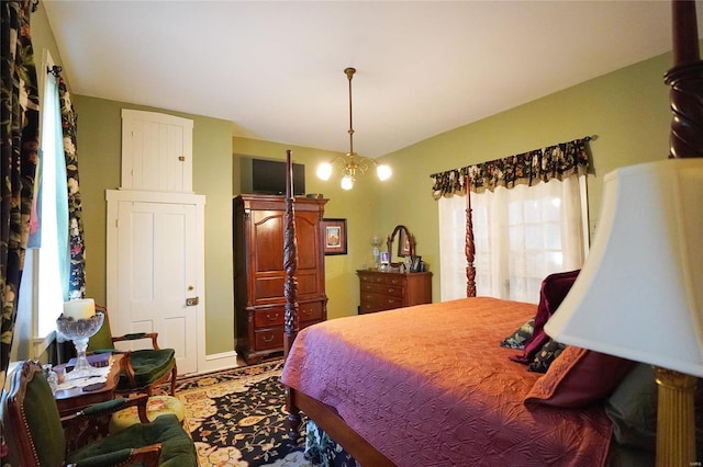 bedroom featuring a notable chandelier