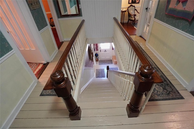 stairs with hardwood / wood-style floors