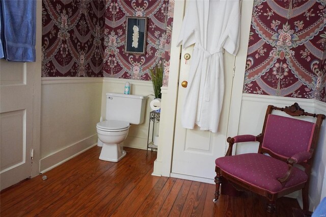 bathroom with hardwood / wood-style flooring and toilet