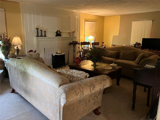 carpeted living room featuring a textured ceiling