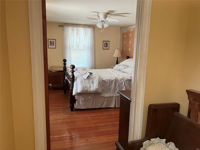 bedroom with ceiling fan and hardwood / wood-style floors