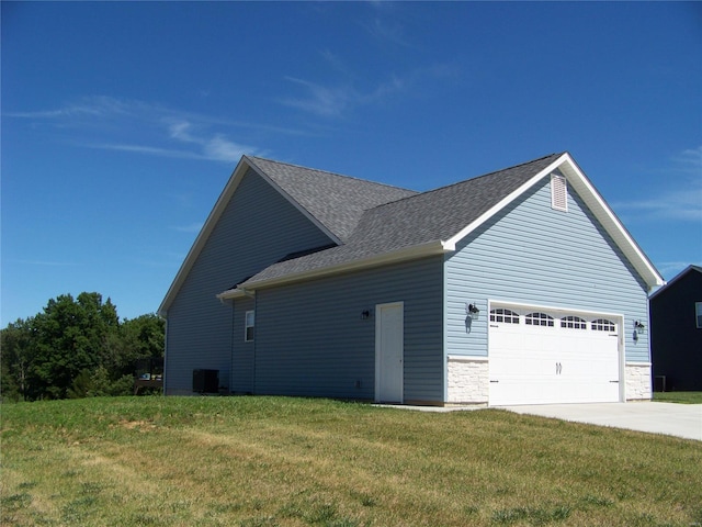 view of home's exterior featuring a lawn, central AC unit, and a garage