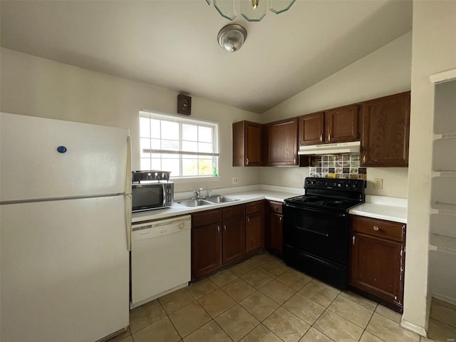 kitchen with black appliances, vaulted ceiling, light tile patterned flooring, and sink