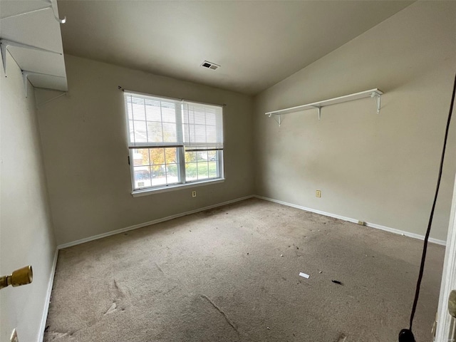 unfurnished bedroom featuring light colored carpet, a closet, and lofted ceiling