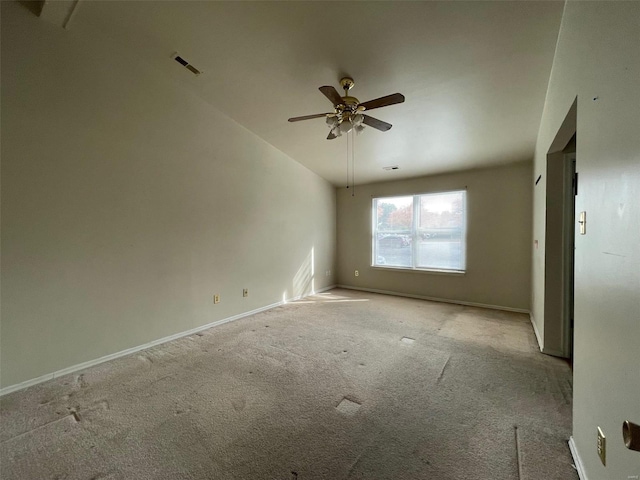 unfurnished room featuring ceiling fan, light carpet, and vaulted ceiling