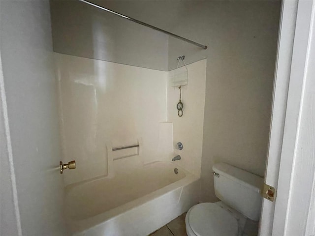 bathroom featuring shower / bathtub combination, toilet, and tile patterned flooring