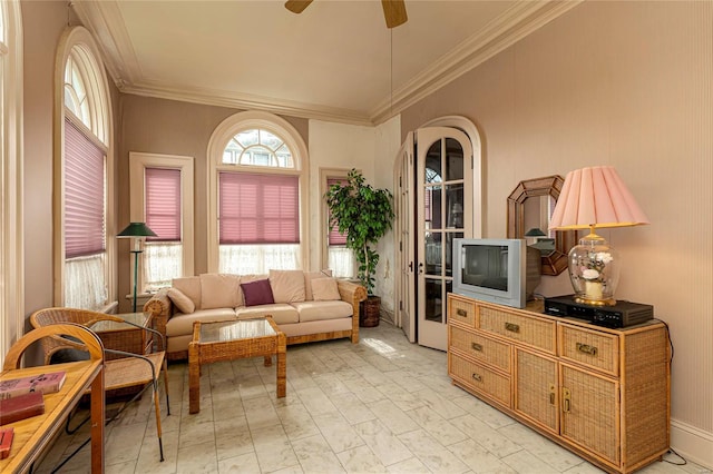 interior space with ceiling fan and ornamental molding