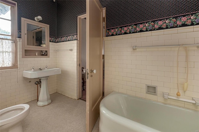 bathroom with toilet, tile walls, tile patterned flooring, and a washtub