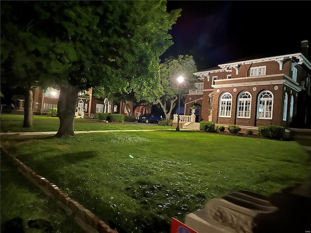 view of yard at twilight