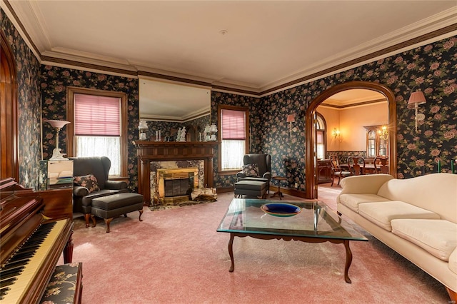 living room featuring ornamental molding, a high end fireplace, and carpet