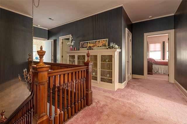 corridor with crown molding and carpet flooring