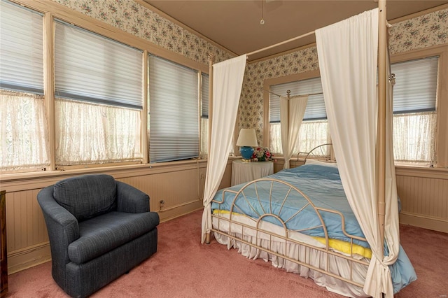 carpeted bedroom with wood walls