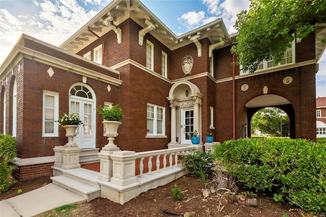 view of front of house featuring french doors and brick siding