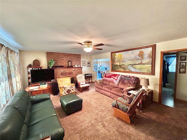 living room with ceiling fan, carpet floors, and a fireplace