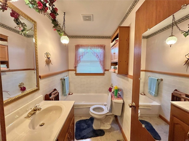 bathroom featuring tile patterned floors, a tub, vanity, and toilet