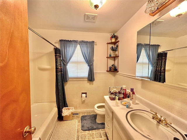 full bathroom featuring vanity, shower / bath combo, tile patterned floors, toilet, and a textured ceiling