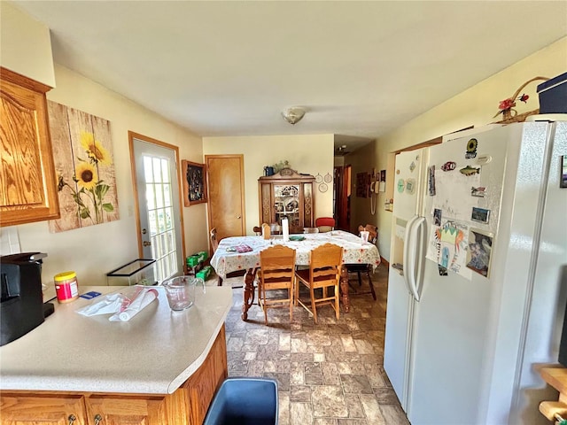 kitchen featuring white refrigerator with ice dispenser