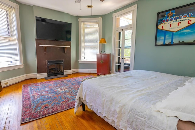 bedroom with french doors and hardwood / wood-style floors