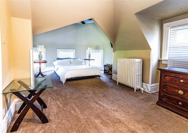 bedroom with lofted ceiling, radiator, and carpet