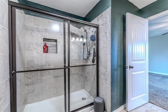 bathroom with tile patterned flooring and a shower with shower door