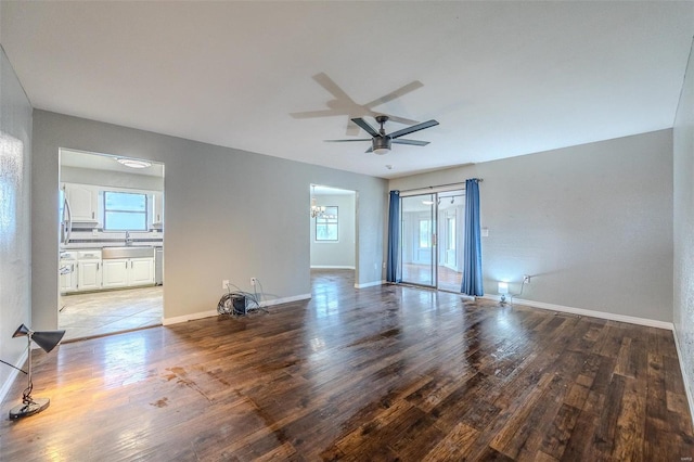 spare room featuring a wealth of natural light, ceiling fan, light wood-type flooring, and sink