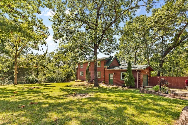 view of yard with a garage and fence