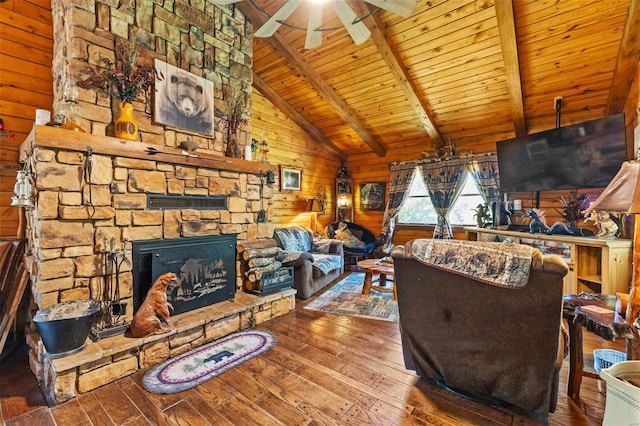 living area featuring lofted ceiling with beams, a stone fireplace, wooden walls, wood ceiling, and wood-type flooring