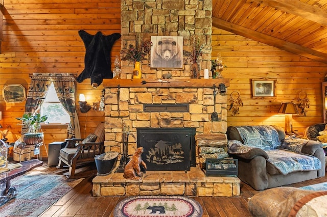 living area featuring vaulted ceiling with beams, wood ceiling, a fireplace, and hardwood / wood-style floors