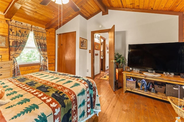 bedroom with lofted ceiling with beams, wooden ceiling, and hardwood / wood-style floors