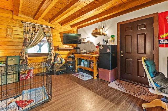 interior space with wooden ceiling, wooden walls, beam ceiling, and wood finished floors