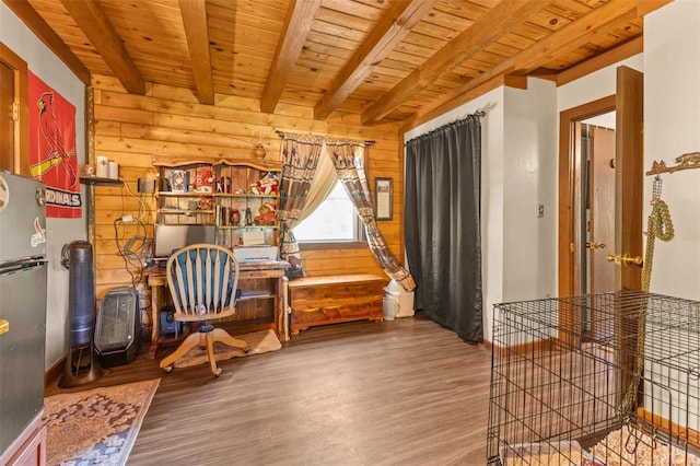 sitting room featuring wood walls, beamed ceiling, wooden ceiling, and wood finished floors