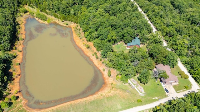 drone / aerial view featuring a water view and a view of trees